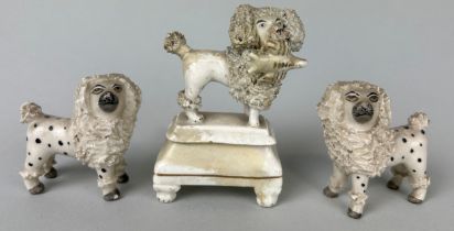 A GROUP OF THREE CERAMIC DOGS POSSIBLY STAFFORDSHIRE (3) Largest 10cm H