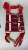 A TIBETAN TEXTILE BAG WITH SHELLS, 28cm x 25cm
