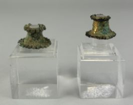 A PAIR OF PRE-COLUMBIAN TUMBAGA LABRETS, 2cm x 1.5cm each. On perspex stands tallest 6cm