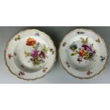 A PAIR OF 19TH CENTURY MEISSEN DISHES PAINTED WITH FLOWERS, 23cm D