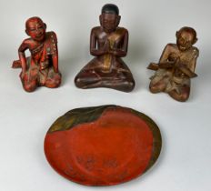 A GROUP OF THREE CARVED WOODEN BUDDHA'S ALONG WITH A RED AND BLACK LACQUERED TRAY, Largest Buddha