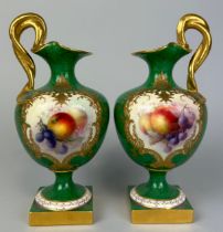 A PAIR OF ROYAL WORCESTER GREEN PAINTED PEDESTAL VASES BY RICHARD SEBRIGHT WITH GILT SERPENT HANDLES