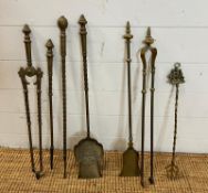 A selection of brass fireside tools