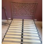 A metal bed frame with scrolling ends 4ft 6