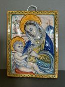 A ceramic painted wall hanging plaque depicting Mary and child 20cm x 27cm