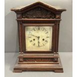 A wooden eight day mantel clock