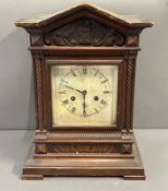 A wooden eight day mantel clock