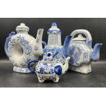 A selection of four Chinese blue and white tea pots to include a doughnut shaped and a miniature