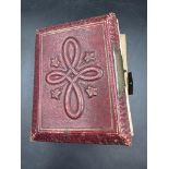 A red leather Victorian photograph album with contents