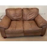 A two seater leather sofa (H78cm W154cm D94cm)