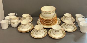 A part tea service by Wedgwood "Strawberry" to include 11 side plates, 6 cups , milk jug, 7 saucers,