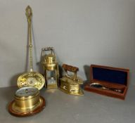 A small selection of quality brass to include an iron, a boxed magnifying glass and a barometer