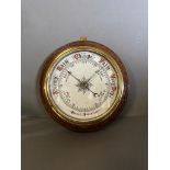 A carved oak English Aneroid Barometer