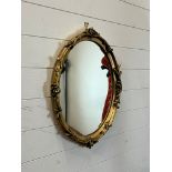 An oval mirror 60cm x 48cm