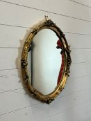 An oval mirror 60cm x 48cm