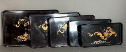 A set of five Chinese lacquered trays with golden central dragons