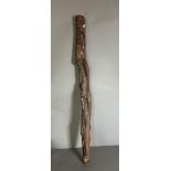 A Tribal carved club or staff with snakes and monkeys etc