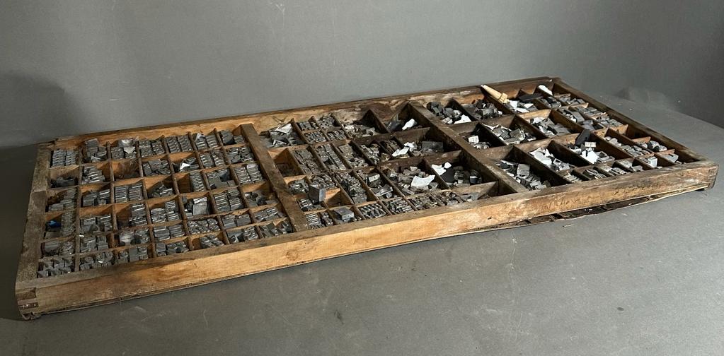 A vintage printers tray with printing blocks