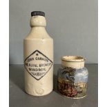 Two stoneware items, A Royal Windsor brewery bottle and a painted jar of a waterside scene