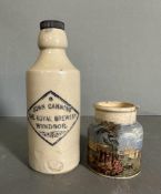 Two stoneware items, A Royal Windsor brewery bottle and a painted jar of a waterside scene