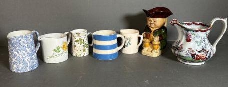 A selection of ceramic jugs various makers to include T.G.Green, Cornish ware and a Toby jug