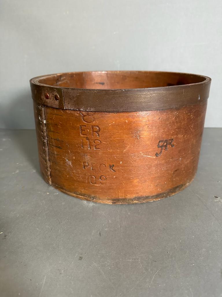 A vintage grain measuring barrel