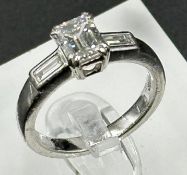 Diamond ring with centrally set emerald cut diamond, approx 6.48mm x 5.03mm x 3.34mm, stated