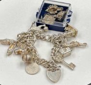 A silver charm bracelet with additional charms