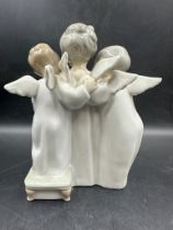 A Lladro figure of three angelic choristers