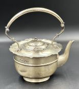 A silver teapot with pie crust design, hallmarked for Birmingham by JS & S 1902 (Approximate Total