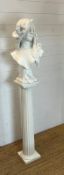 A fluted wooden Corinthian columns pedestal with a bust of a maiden