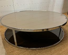An Italian contemporary circular smoked glass coffee table on chrome frame by Minotti (H34cm
