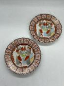 A pair of Japanese plates, the centre enamel decorated with elders and scrolling pattern to edge (