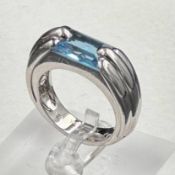 A single stone Audemars Piguet ring consisting of a rectangular mixed cut blue topaz stone (12.1mm x