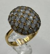 An 18ct gold cocktail ring with a cluster white stone design. Approximate weight 6.6g and size P