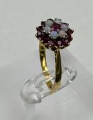 An 18ct gold opal and ruby cluster ring, approximate size N