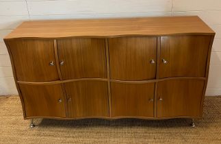 A contemporary wave front sideboard with eight compartments (H83cm W142cm D38cm)