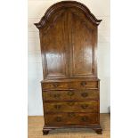 A Queen Anne revival walnut panelled cabinet on two over three chest with block feet, brass