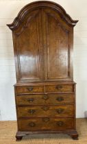 A Queen Anne revival walnut panelled cabinet on two over three chest with block feet, brass