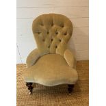 A Victorian button back nursing chair upholstered in a pale green velvet