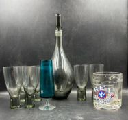 A selection of glassware to include a mid century grey smoked glass decanter and six matching