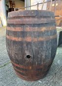 Two reclaimed timber metal banded whisky barrels (H127cm Dia67cm) ( H110cm Dia 75cm)