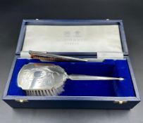 A Mappin and Webb hallmarked Child's silver brush and comb set, cased with original receipt.