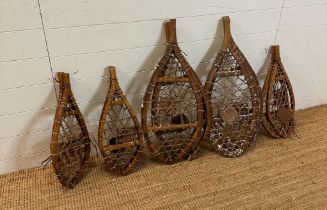 Five pairs of vintage wooden webbed snow shoes