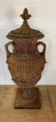 A terracotta stone garden urn of amphora form and scrolling handles (H160cm W66cm)