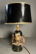 An Eagle table lamp with a cast eagle sculpture to side on a marble base