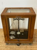 Wandy George and Becker balance scales, sat inside a wooden and glass case (H52cm W40cm D28cm)