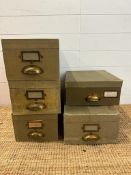 A selection of six green vintage storage boxes