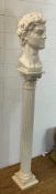 A fluted wooden Corinthian column pedestal with a bust of a Greek God