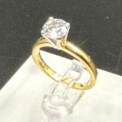 A Diamond set single stone ring, round brilliant cut diamond measuring 6.65mmx 6.64mm x 4.2mm depth,